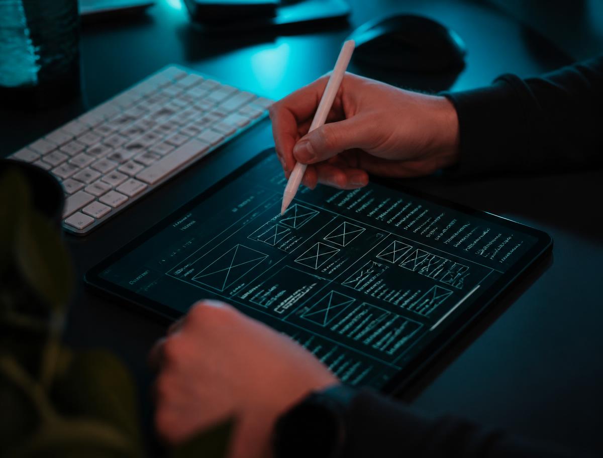 Designer sketching website wireframes on a tablet